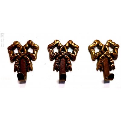 Attaccaglia mod. FIOCCO in ottone oro antico