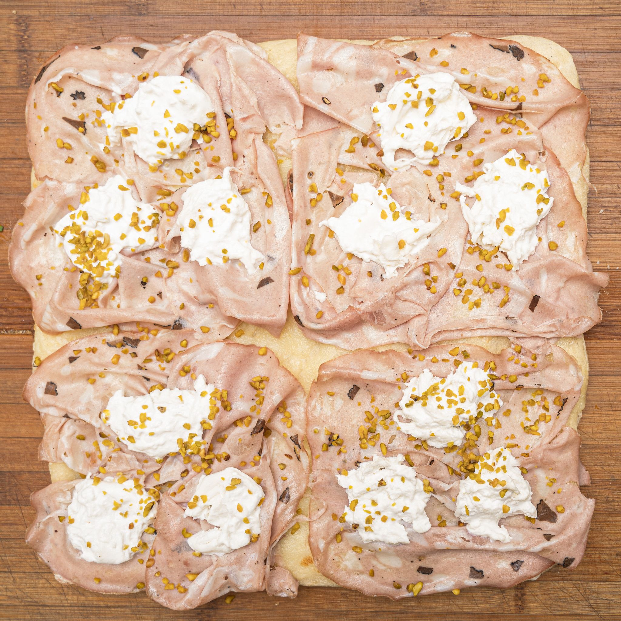TRANCIO DI PIZZA BIANCA CON PESTO DI PISTACCHIO, BURRATA DI PUTIGNANO E MORTADELLA AL TARTUFO